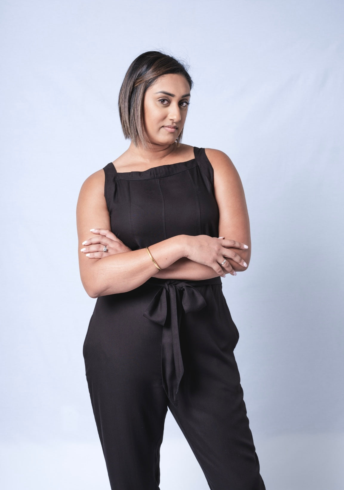 All In One Jumpsuit Model showing front of jumpsuit. Waistband tied to front