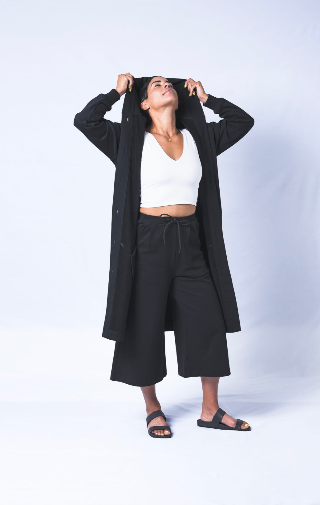 Somewhere between a cardigan and a coat...Its a Coatigan! Hand-picked black cotton poly blend fabric ensures lasting comfort no matter how many times you wash it. Features oversized hood for extra comfort. Sizes Small-Large available.