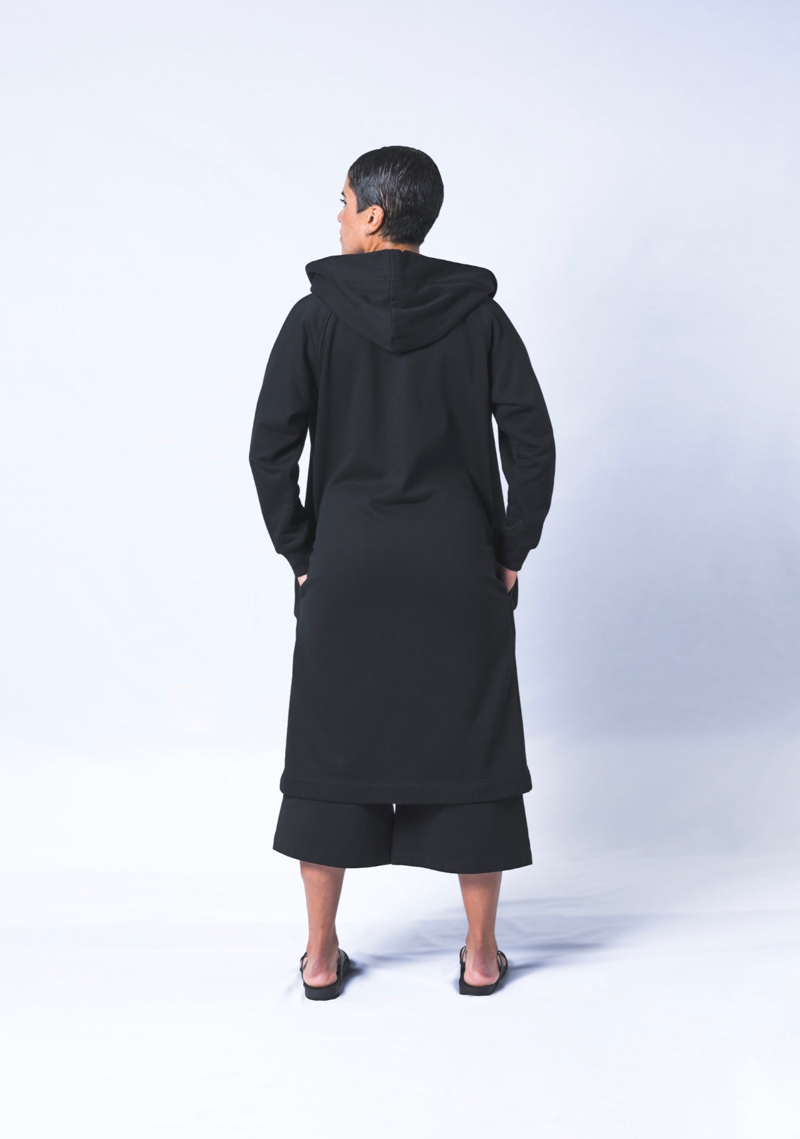 Somewhere between a cardigan and a coat...Its a Coatigan! Hand-picked black cotton poly blend fabric ensures lasting comfort no matter how many times you wash it. Features oversized hood for extra comfort. Sizes Small-Large available.