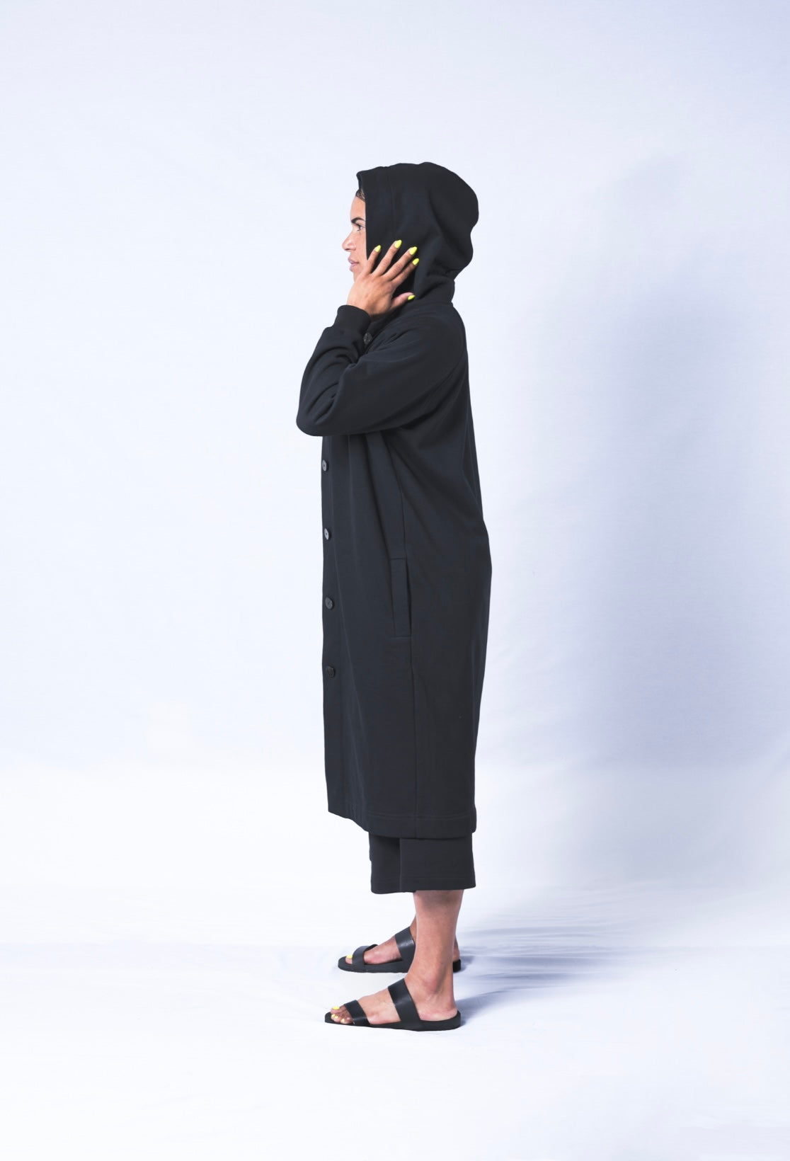 Somewhere between a cardigan and a coat...Its a Coatigan! Hand-picked black cotton poly blend fabric ensures lasting comfort no matter how many times you wash it. Features oversized hood for extra comfort. Sizes Small-Large available.