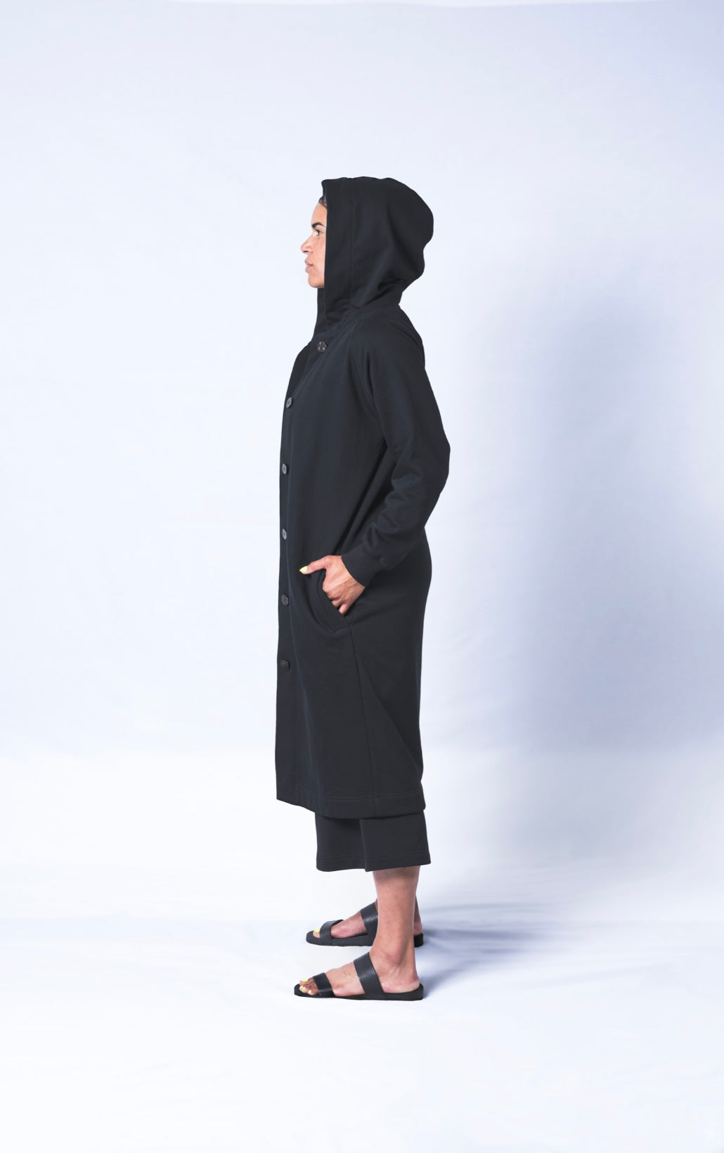 Somewhere between a cardigan and a coat...Its a Coatigan! Hand-picked black cotton poly blend fabric ensures lasting comfort no matter how many times you wash it. Features oversized hood for extra comfort and deep side poskets. Sizes Small-Large available.