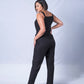 All In One Jumpsuit Model Standing showing back of the jumpsuit. Waistband tied to front