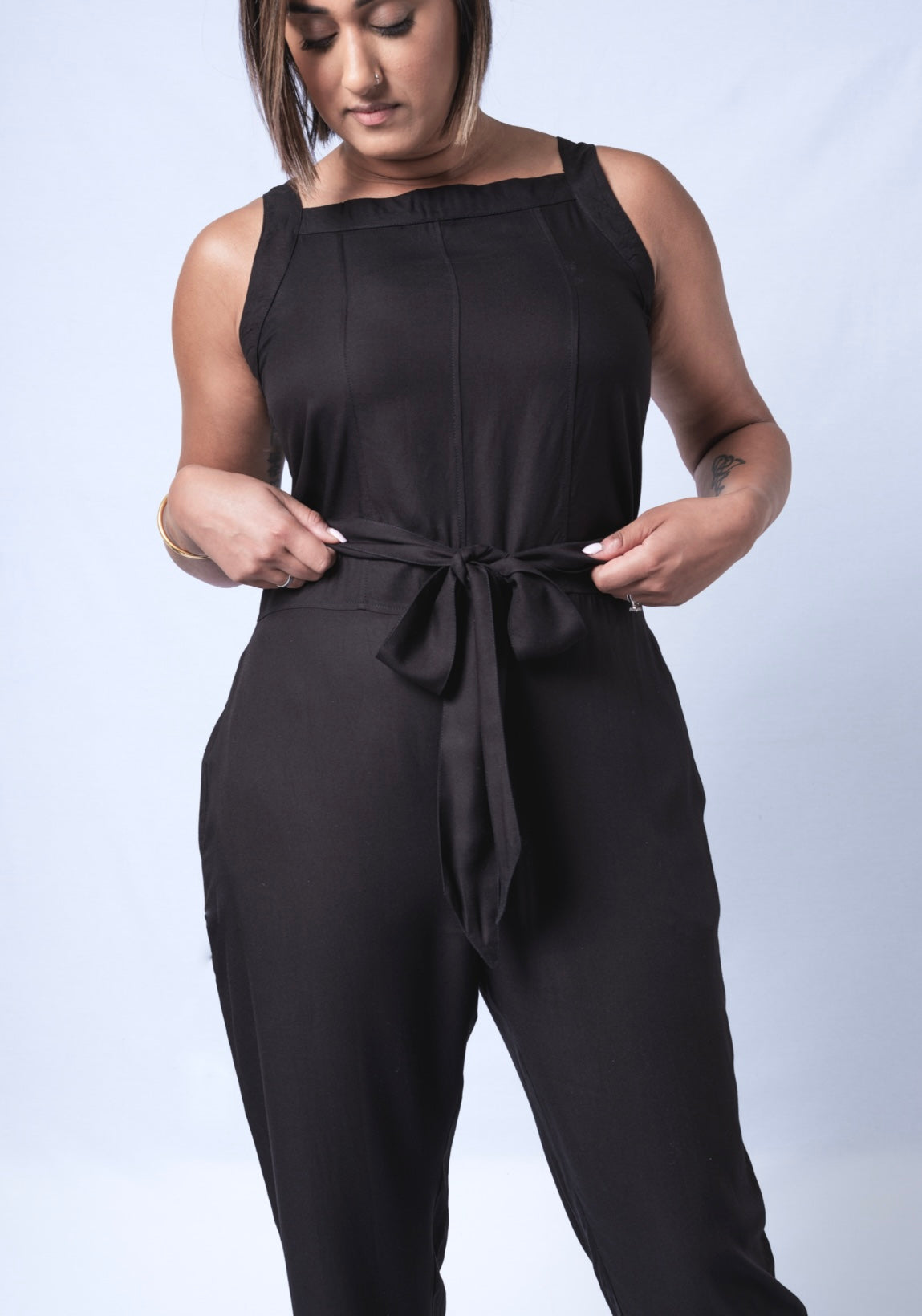 All In One Jumpsuit Model Standing showing waistband. Waistband tied to front