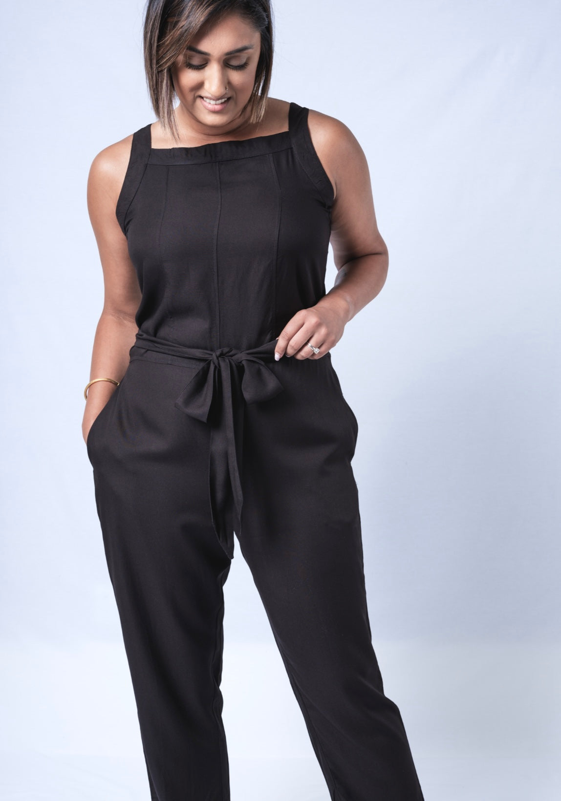 All In One Jumpsuit Model showing front of jumpsuit. Waistband tied to front