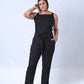 All In One Jumpsuit Model Standing showing front of jumpsuit. Waistband tied to front
