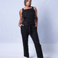 All In One Jumpsuit Model Standing showing front of the jumpsuit. Waistband tied to front and hands in pocket