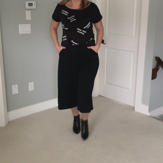 Watch the Travel Graphic Basic Black T-Shirt worn. See all the details up close. Model is wearing a size Medium. Sizes X-small to X-large avaiable. 